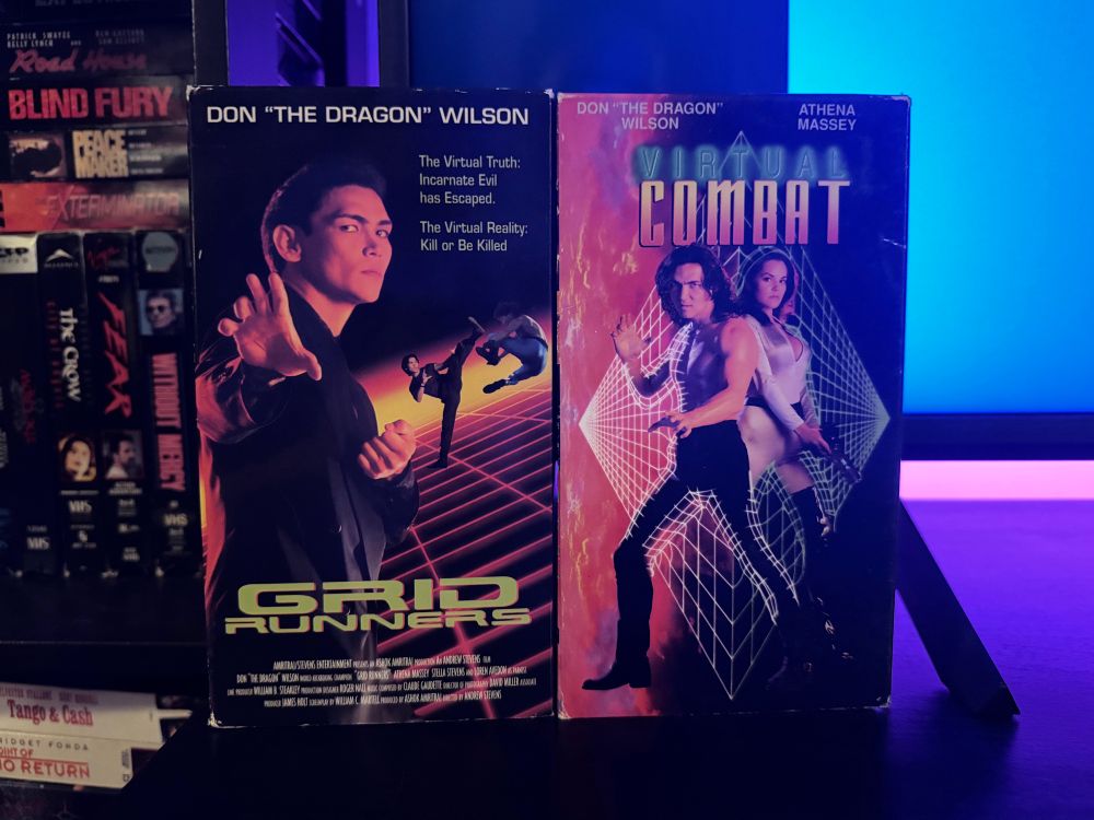 Two vhs tapes of the movie Virtual Combat and the alternative title Grid Runners. 