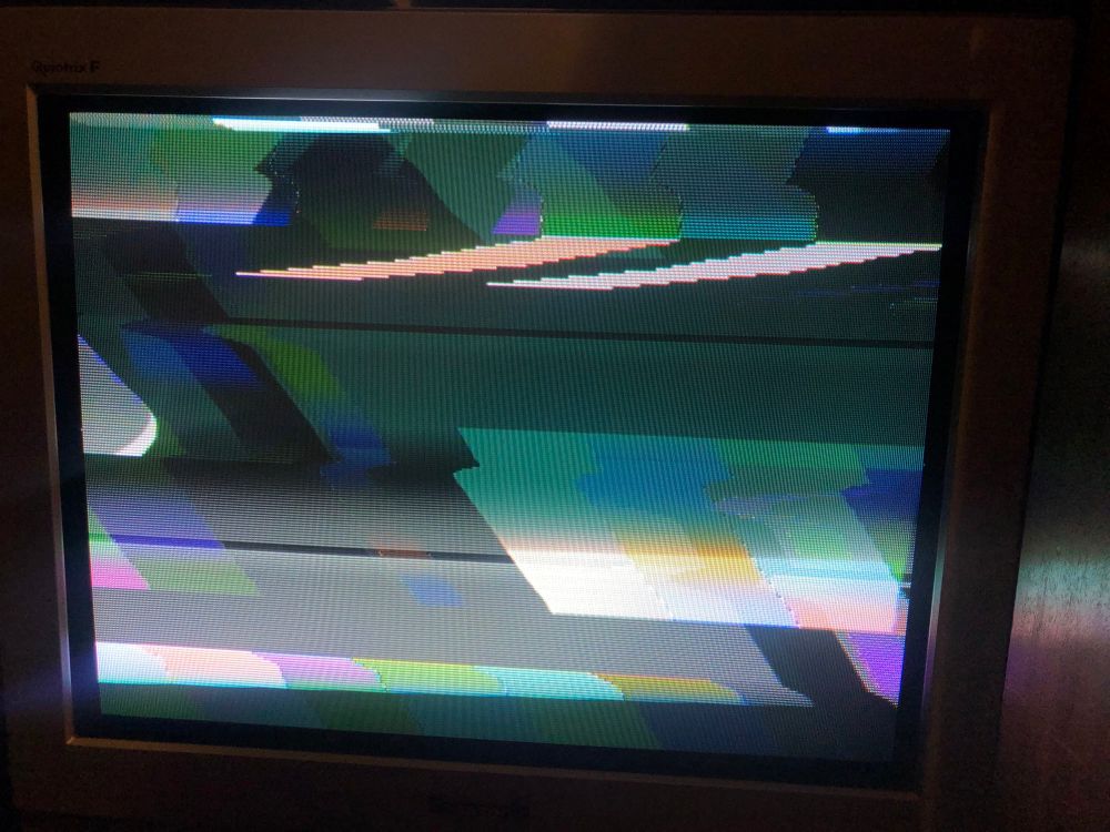 photo of my 90s Panasonic CRT TV displaying two video sources over the top of each other - a set of colour bars and a grey screen