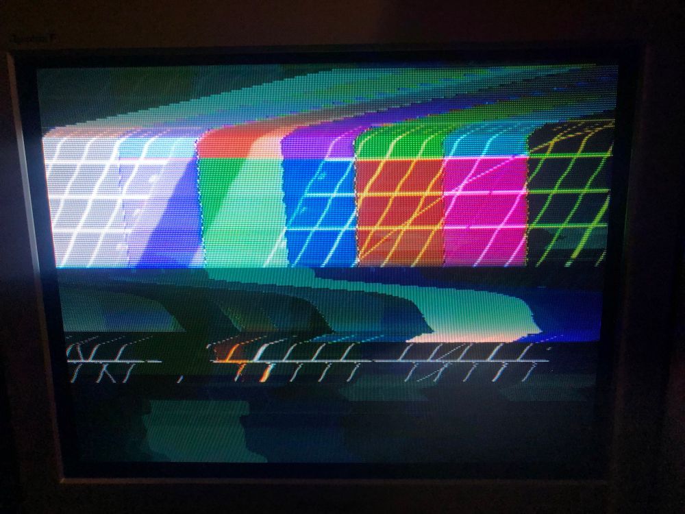 photo of my 90s Panasonic CRT TV displaying two video sources over the top of each other - a set of colour bars and a test pattern