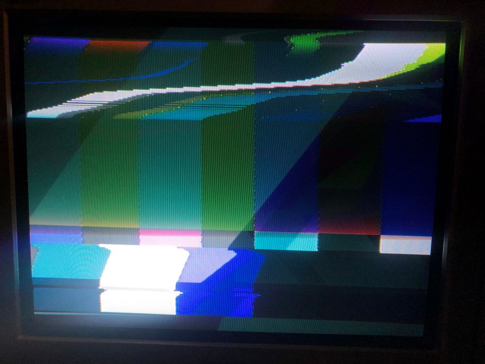 photo of my 90s Panasonic CRT TV displaying two video sources over the top of each other - two sets of colour bars