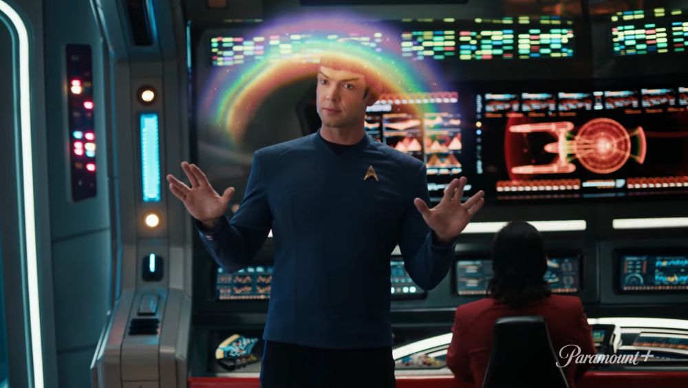 Spock on the bridge of the enterprise  doing a double Vulcan salute tracing out a rainbow. 