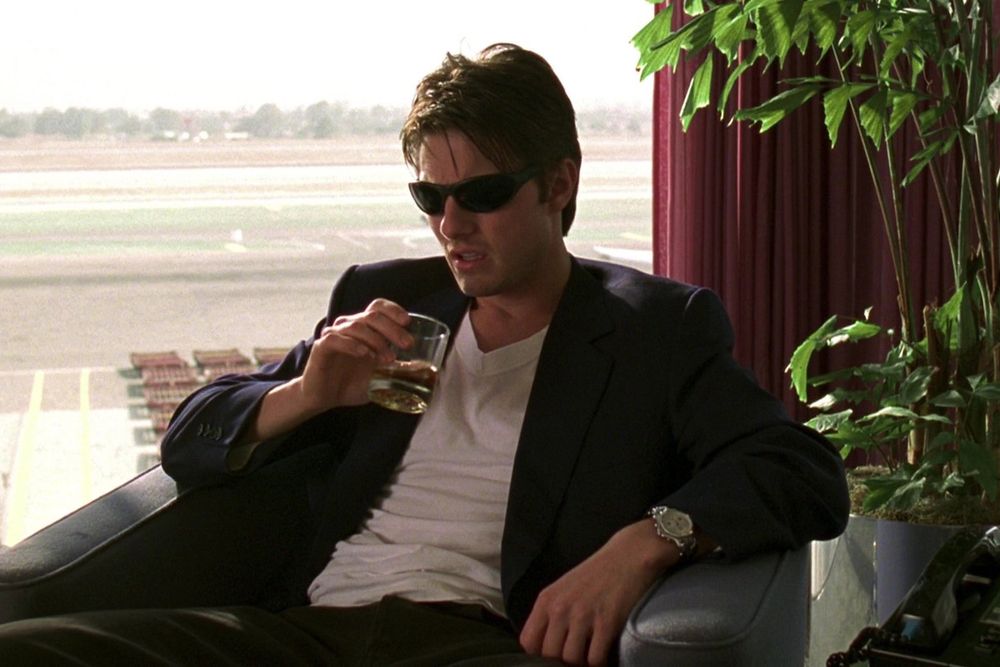 Tom cruise drinking bourbon and looking disgusted and depressed