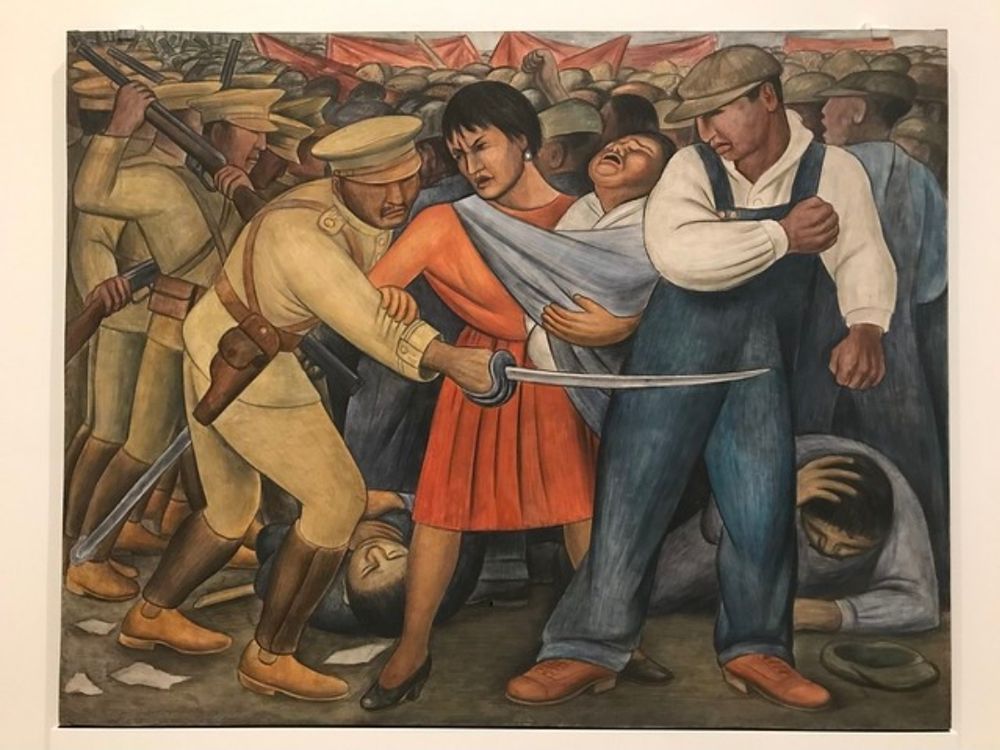 Painting: The Uprising by Diego Rivera, 1931. Depiction of armed soldiers attacking laborers. Forefront is a woman with an infant in her arms resisting a soldiers attack on the workers behind her.