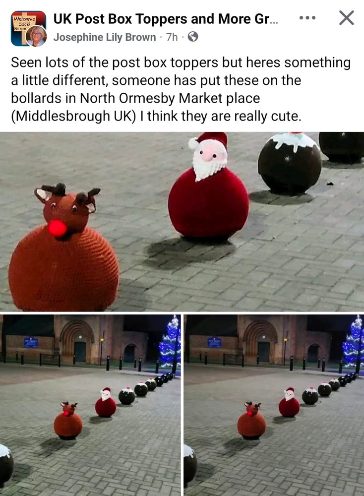 A row of round roadside bollards in North Ormesby Market Place are covered with handmade festive yarn toppers. Closest to the camera is a knitted reindeer bollard cover with a bright red nose. Behind it is a red Santa-themed cover with a white beard and bobble hat. Further along are several dark brown Christmas pudding covers with white “icing” and holly decorations. The photos show the decorated bollards lined up across the paved square at night, with a lit Christmas tree and a building in the background.