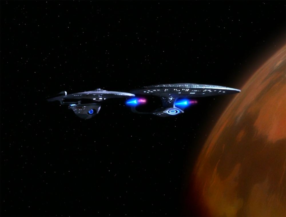 The Hood and the Enterprise in The Next Generation, orbiting a non-descript grubby brown planet that I cannot recall the name of. The ships are side by side, showcasing how much bigger the Galaxy-class is than the Excelsior-class.