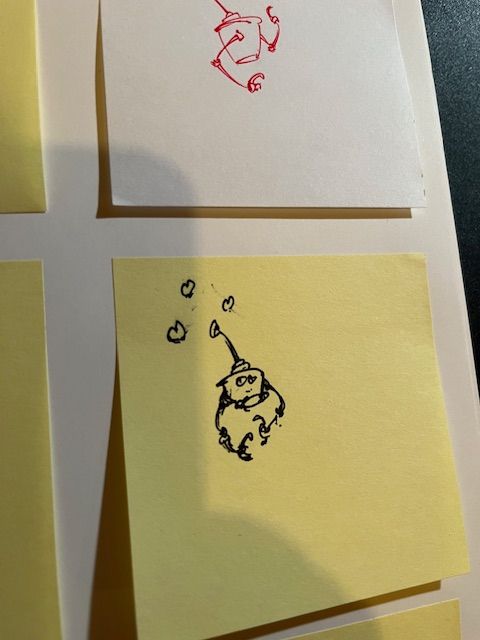 A kinda' beat up robot has three hearts above it's antenna.