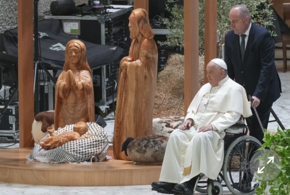 Pope visits a Nativity scene at the Vatican with baby Jesus wrapped in a keffiyeh, Dec. 2024. 