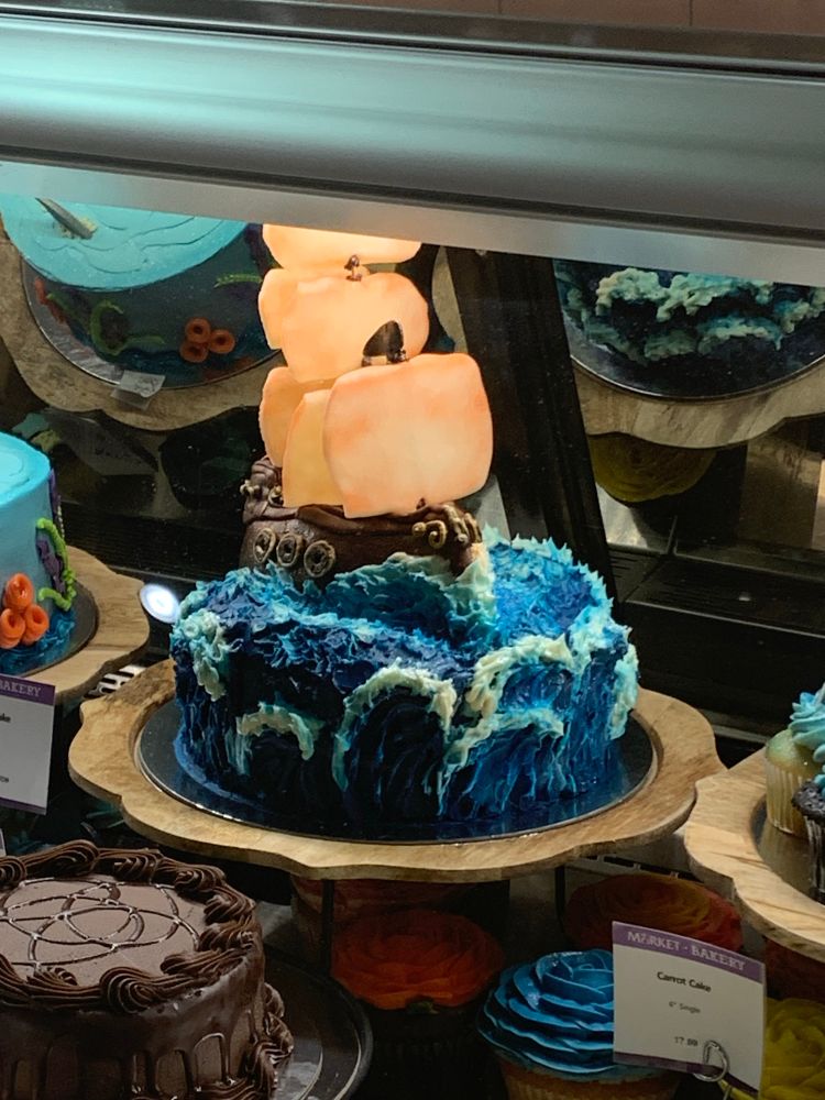 A very well-made cake designed to look like a sailboat on stormy waters