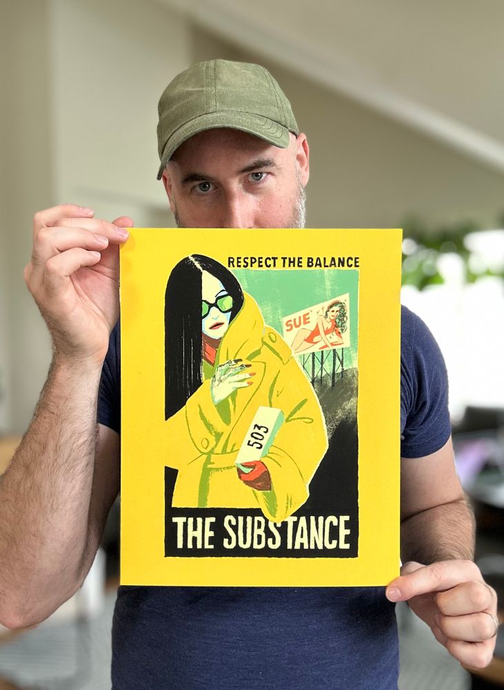 Photo of Levi Hastings holding up an art print based on #TheSubstance for #ECCC25 