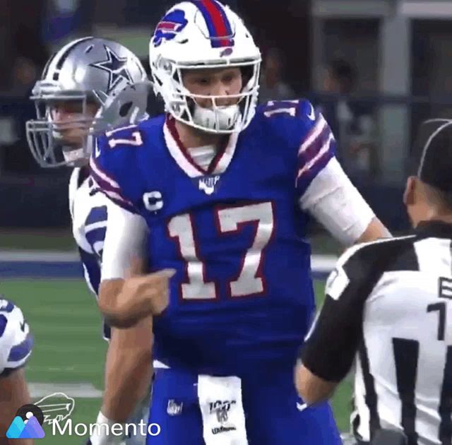 a football player with the number 17 on his jersey is talking to a referee