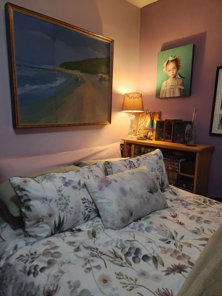 Freshly made bed with floral linens