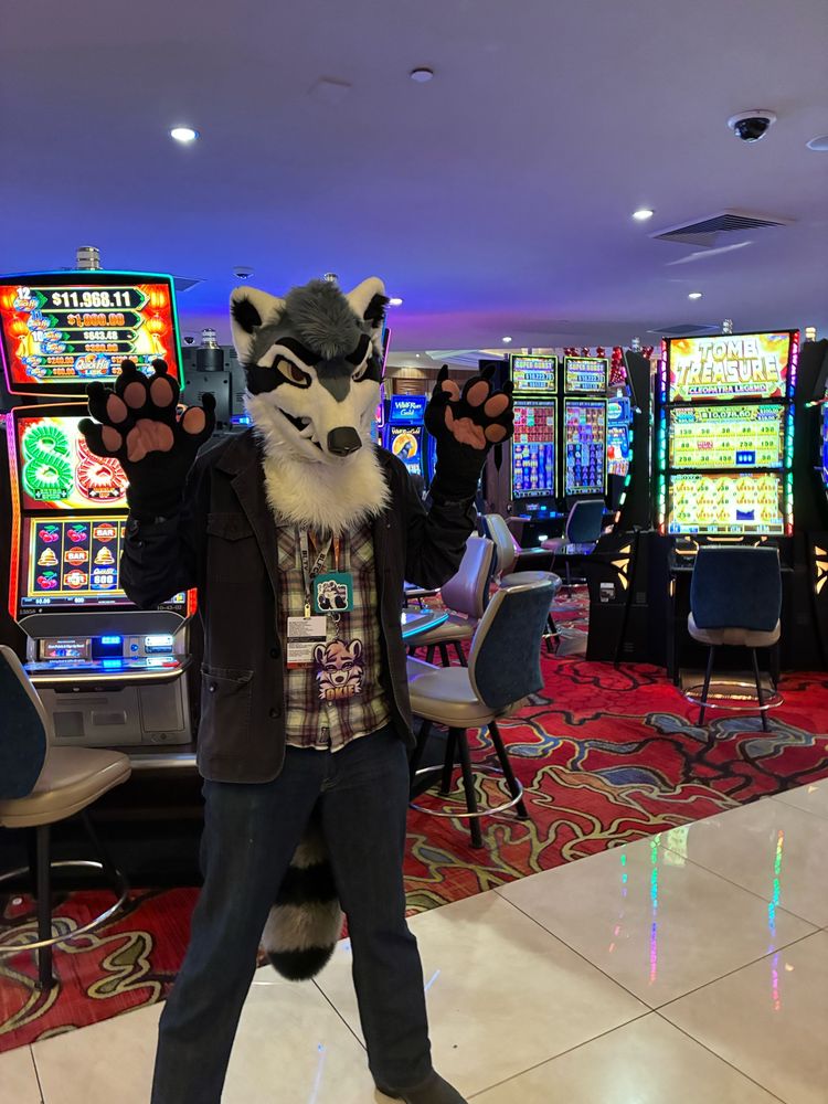 Okie standing in front of slot machines at the Grand Sierra Resort in Reno