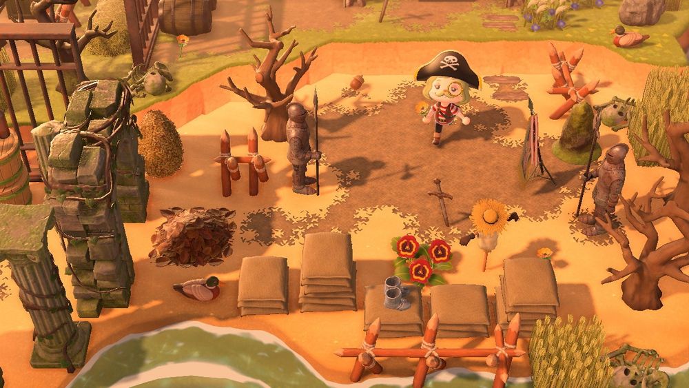 In Animal Crossing: New Horizons, a pirate runs down a beach surrounded by stacked bags, fencing, dead trees, and wheat fields. 