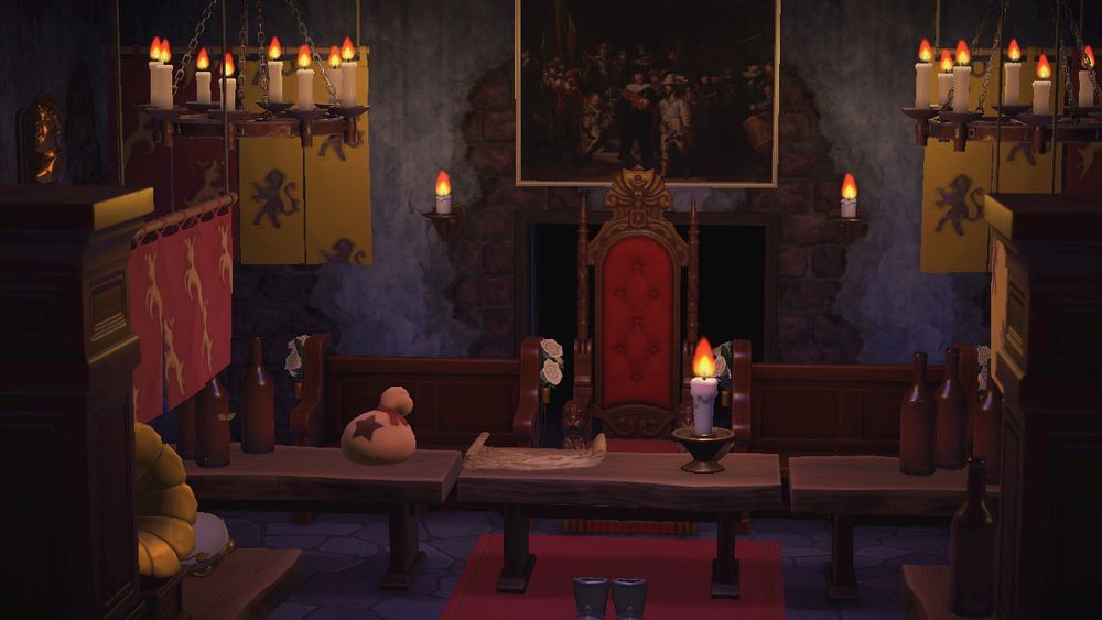 In Animal Crossing: New Horizons, a candlelit stony castle hall featuring hung tapestries and wooden seating areas. A close up of the main throne shows a bag of money and a treasure map on the table. 