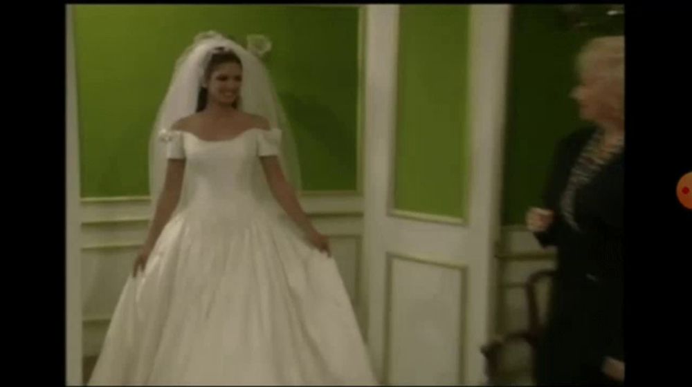 a woman in a white wedding dress and veil