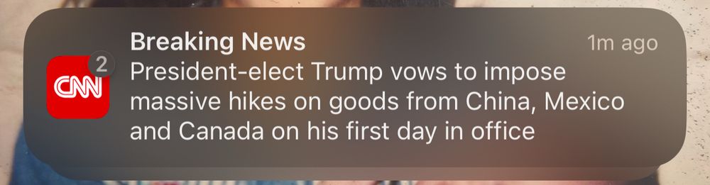 A CNN news alert stating that “President-elect Trump vows to impose massive hikes on goods from China, Mexico, and Canada on his first day in office”
