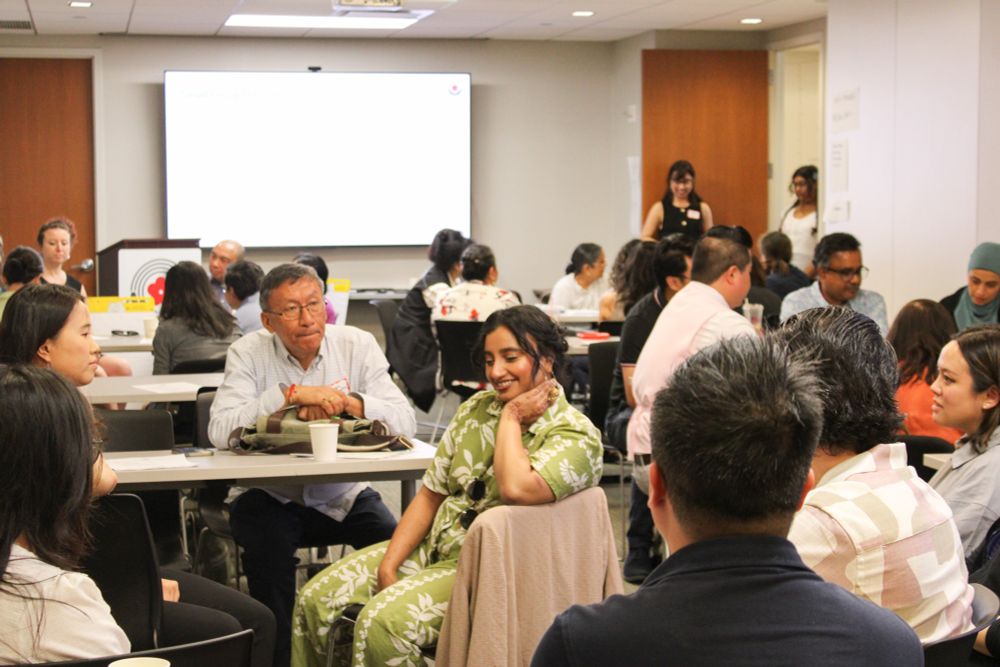 A photo of participants at the Asian American Federation’s member convening talking with each other.