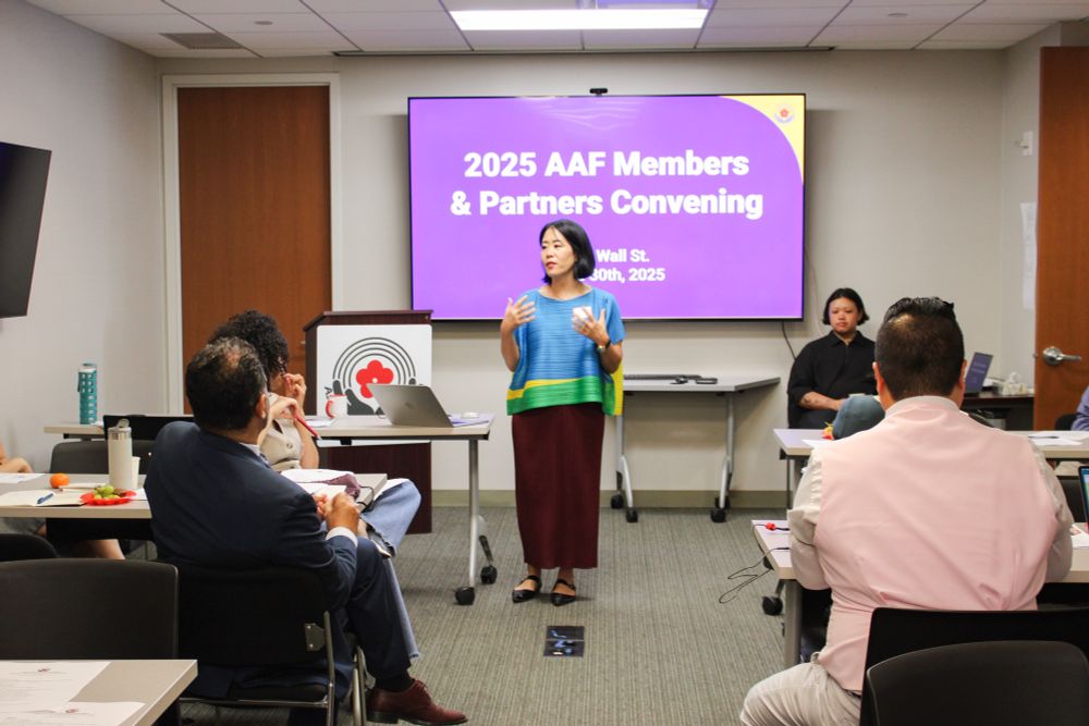 A photo of Asian American Federation Executive Director Catherine Chen speaking to the member convening.