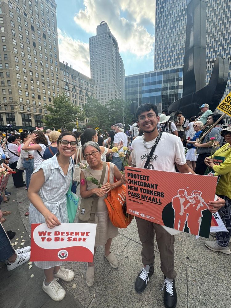 Asian American Federation staff holding signs at a Good Trouble demonstration.