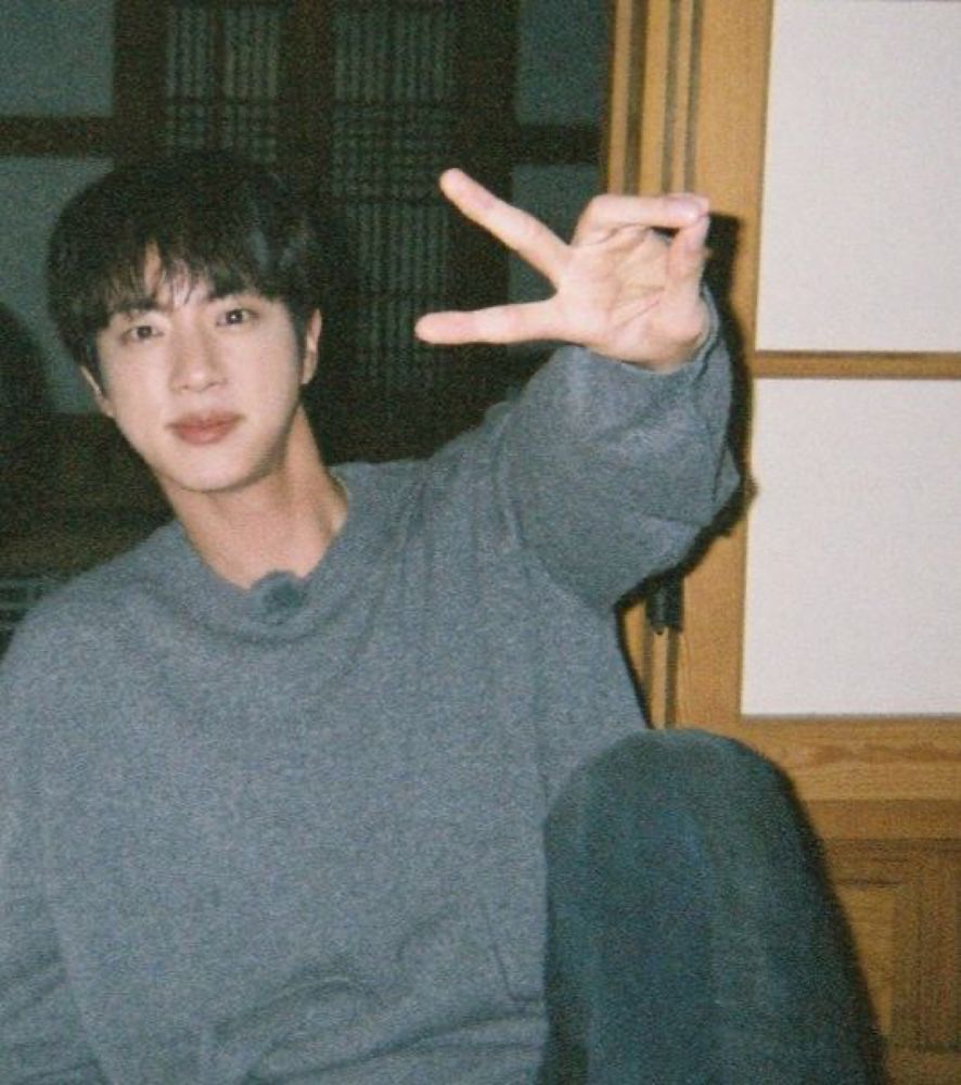 Seokjin in a gray sweatshirt and jeans 
