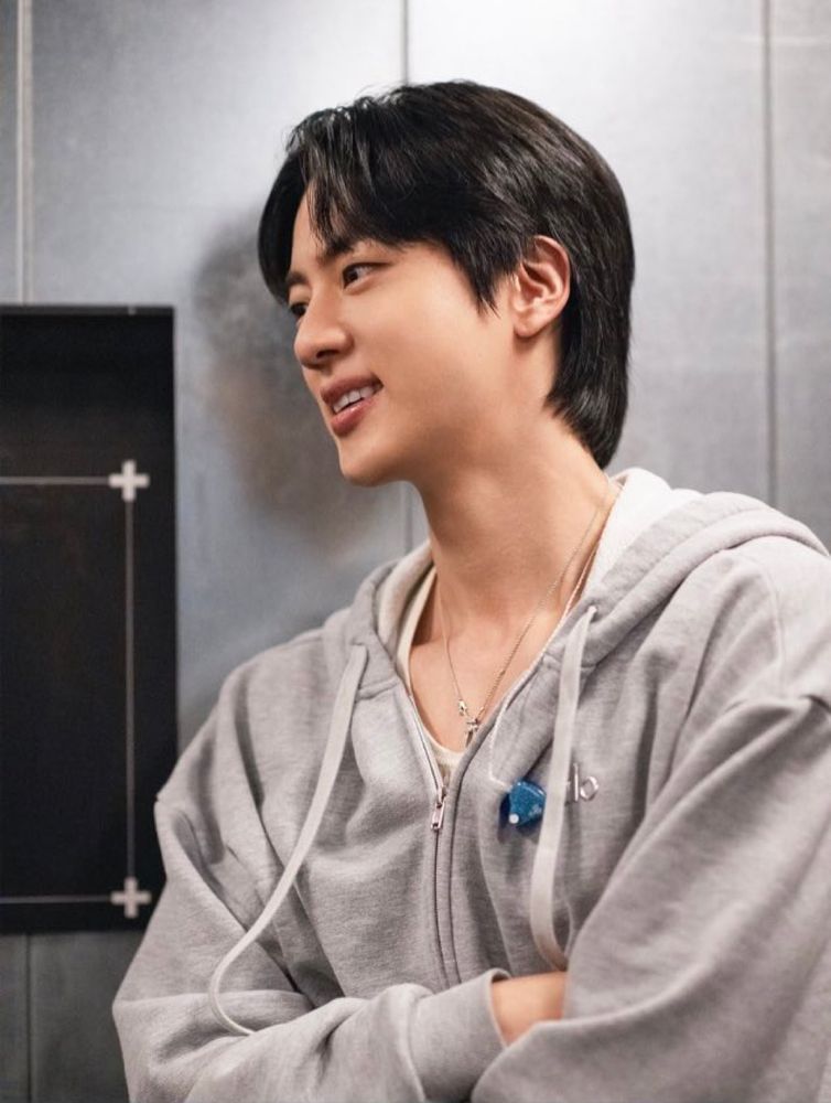 Seokjin in a gray zip up hoodie backstage on tour 