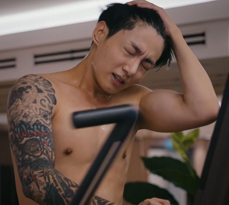 Jungkook shirtless working out on the elliptical 