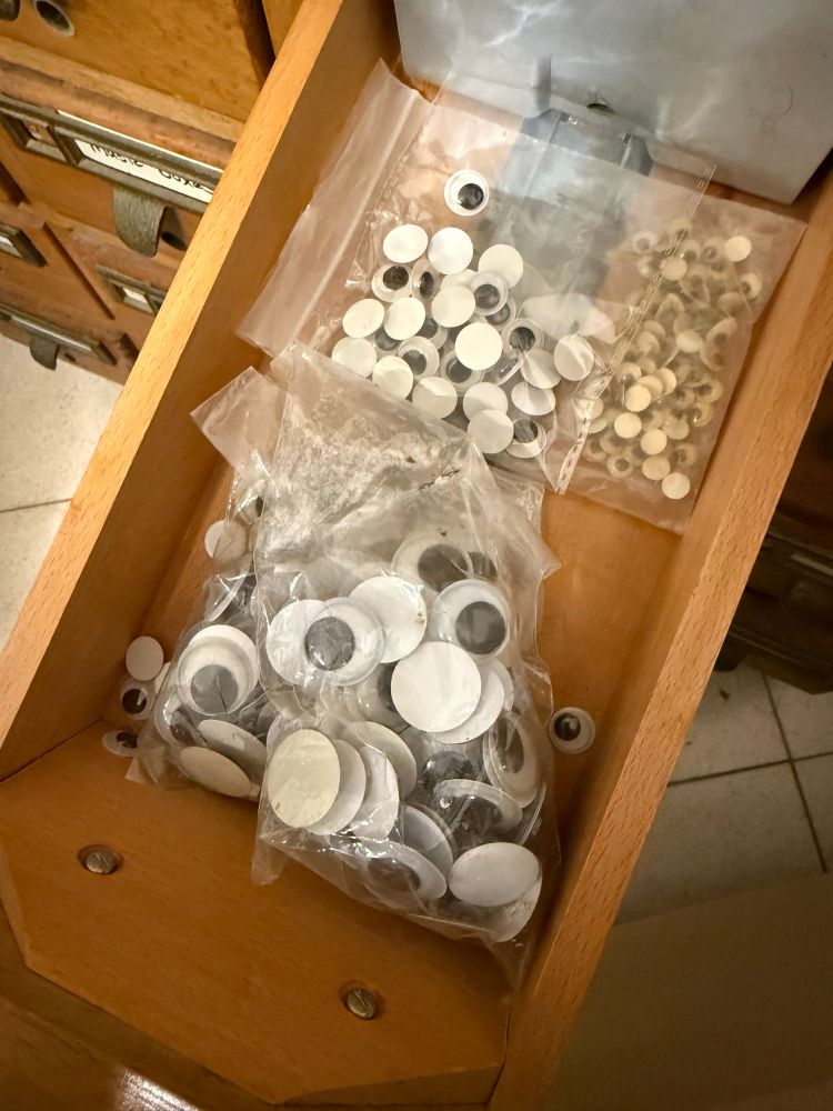 Drawer full of packets of googly eyes of different sizes