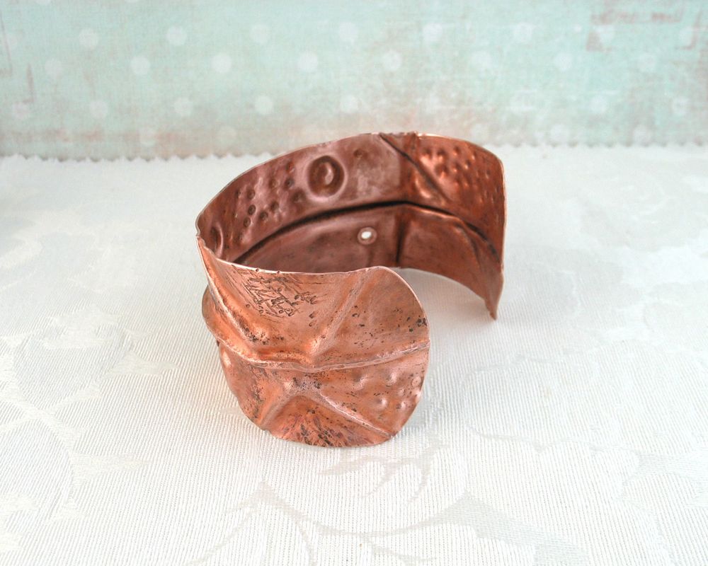 handmade copper cuff bracelet with "I am enough" in tactile contracted Braille.