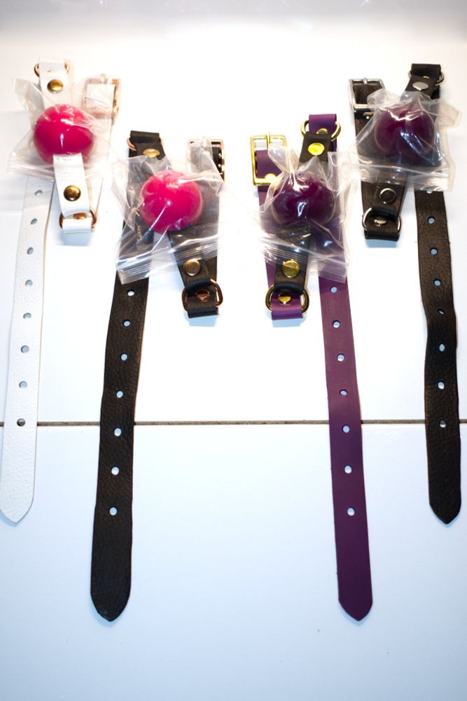 Four ball gags of various colors including black, purple, and white. Other colors not pictured but available