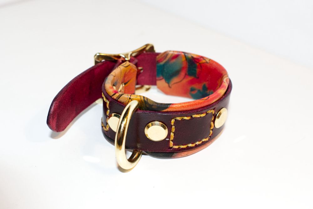 A wine red leather cuff with the butterfly floral backing. 