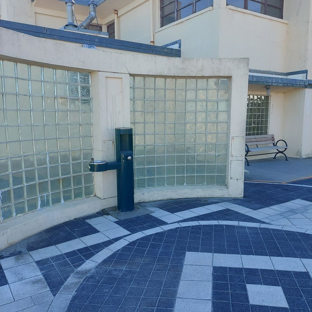 A structure made of stucco, tile, and fogged glass, housing a water fountain

Nantasket Beach, Massachusetts