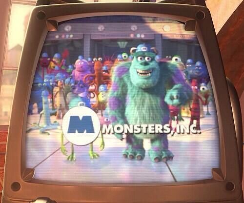 Image of Mike Wazowski covered by the Monsters Inc logo.