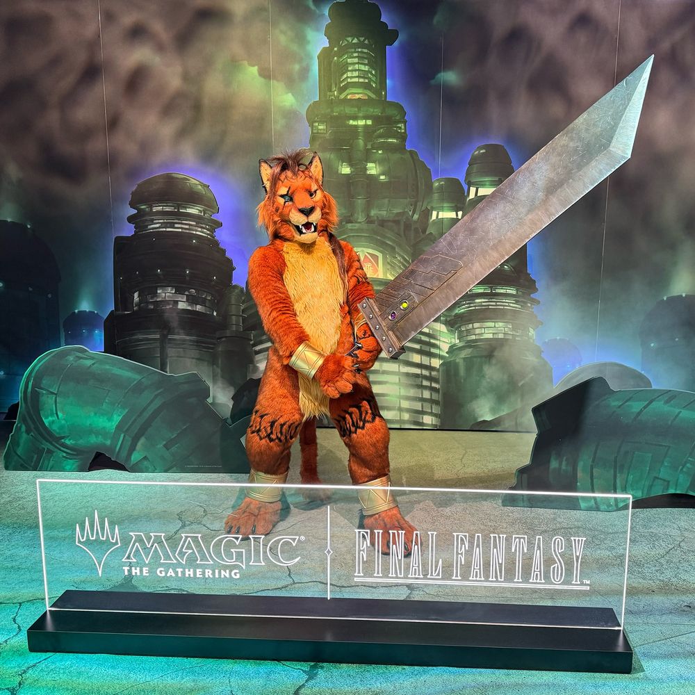 A Red XIII fursuiter holds up a giant buster sword from Final Fantasy VII in front of a backdrop that depicts the Shinra building in Midgar. A sign in front of Red XIII says "Magic The Gathering | Final Fantasy"