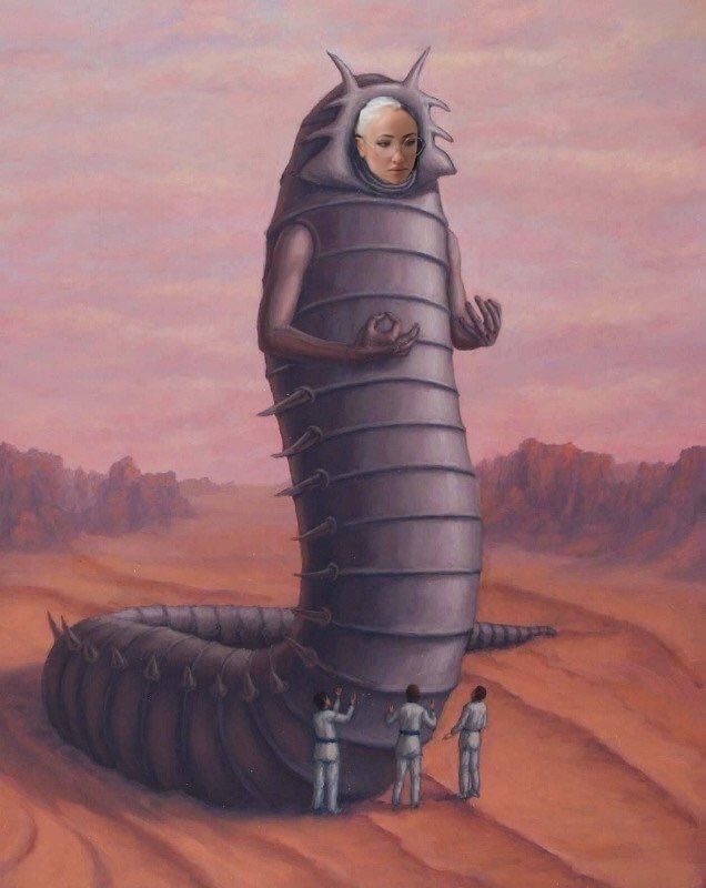 Giant space wurm with a woman's face photoshopped onto it being worshipped by 3 men in the desert. 