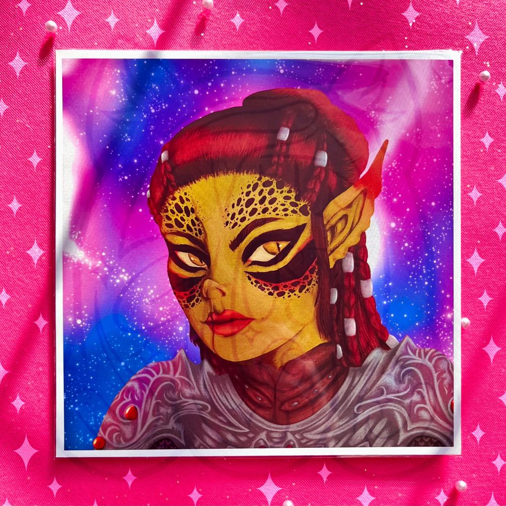 A square 8x8” print of the previous image (a painting style bust of Lae’zel from Baldurs Gate 3), photographed on top of a bright fuchsia pink background. Sparkles are scattered throughout.