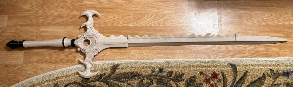 A fully 3d printed life sized replica of the Sword of the Creator from Fire Emblem: Three Houses but it still needs to be assembled with a dowel rod since it’s currently in separate pieces 