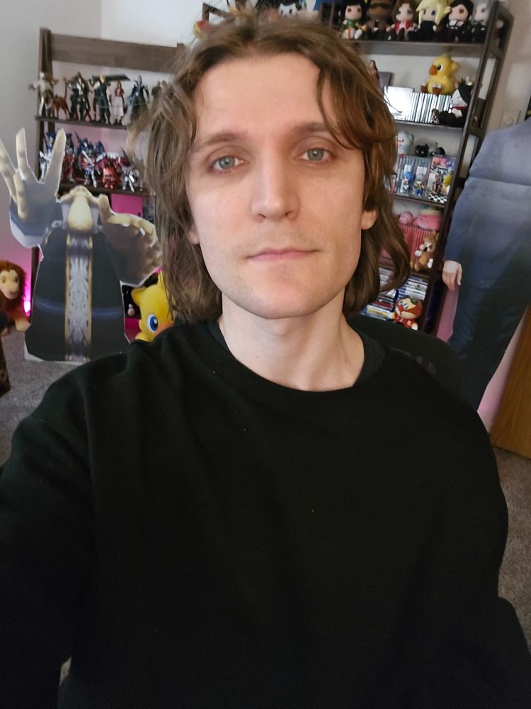 Person (me) standing in front of shelves with video games on them