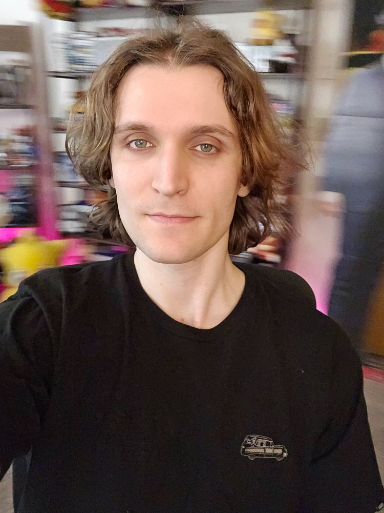 Person (me) sitting in front of a blurry background 