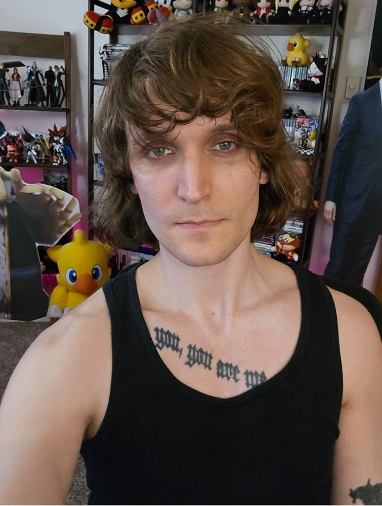 Person (me) in front of bookshelf of games 