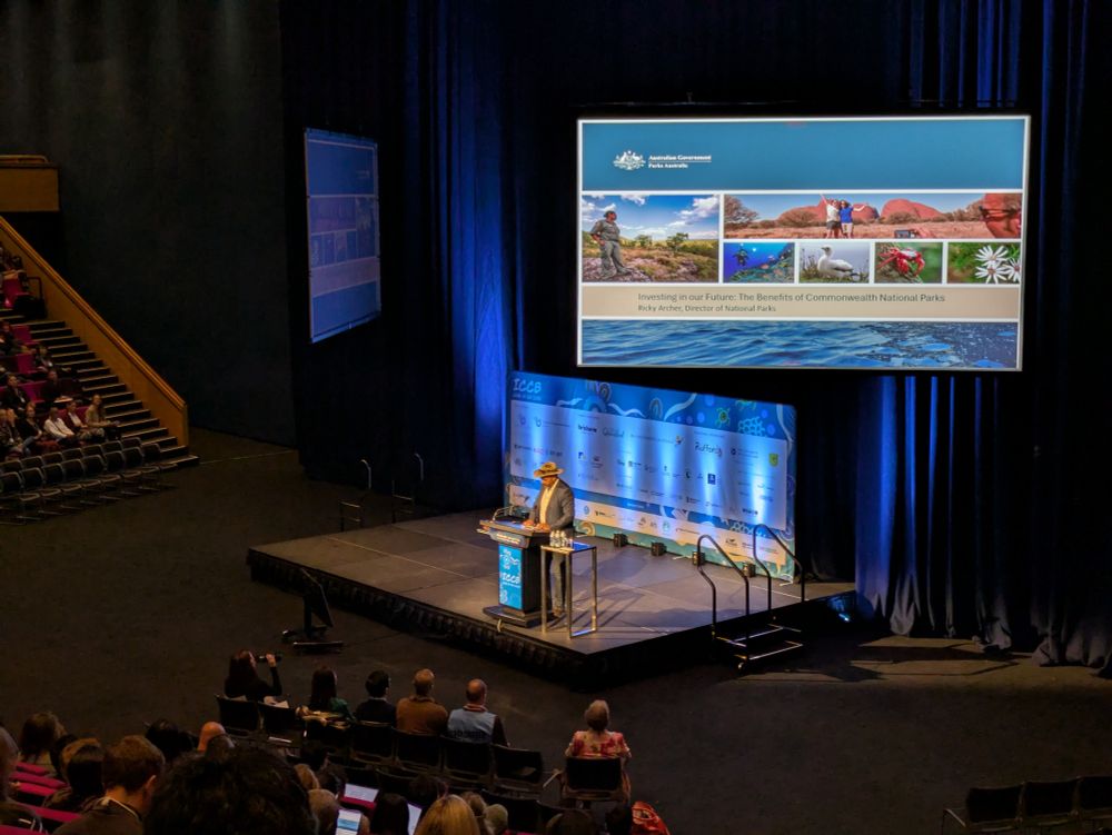 Ricky Archer, the first Indigenous Director of National Parks at Parks Australia, addresses the audience at ICCB 2025.