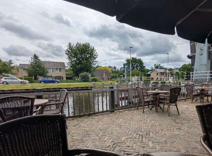 canal view from a brewery. the bridge is up and a boat has recently passed