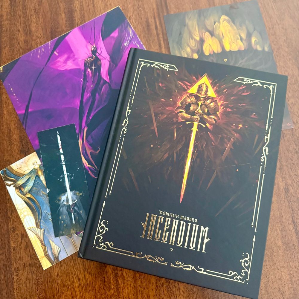 The Incedium book with a few of its pack in prints, postcards, and a bookmark.