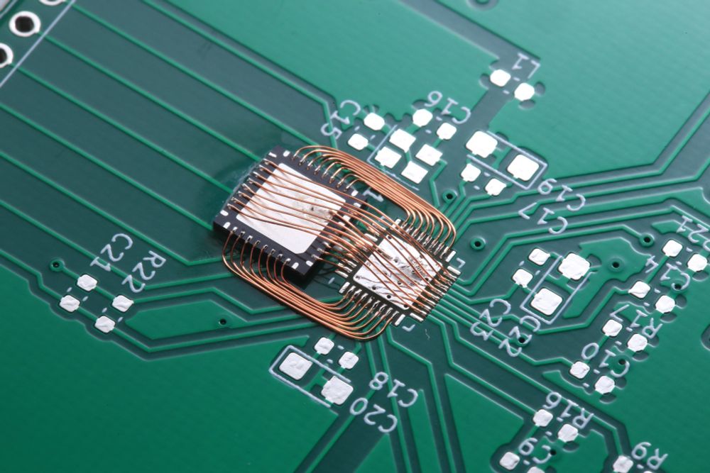 enamel wire bodging an IC dead-bug style to a circuit board due to incorrectly designed footprints.