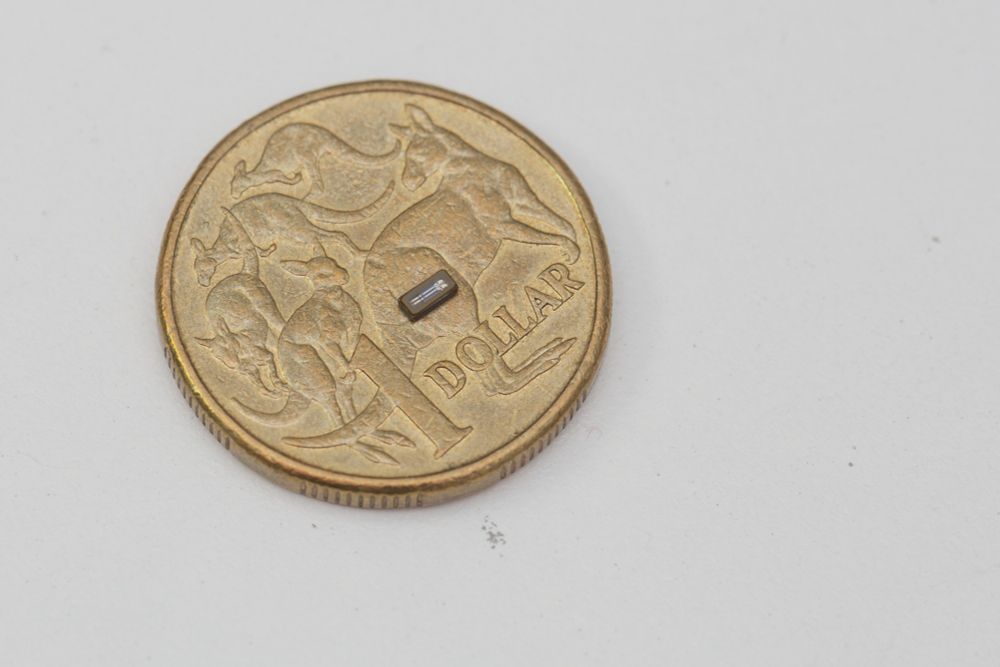 Australian dollar coin with a surface mount 32.768kHz crystal component.