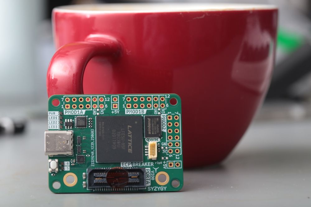 Circuit board in-front of a red coffee mug