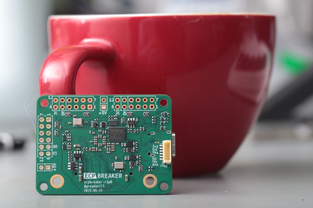 Circuit board in-front of a red coffee mug