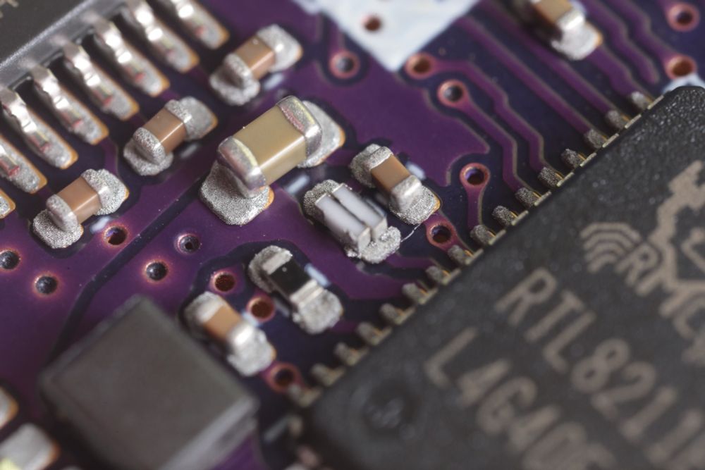 Components on solderpaste. The center of the image is two resistors back to back sitting sideways on the space typically taken by a single resistor.