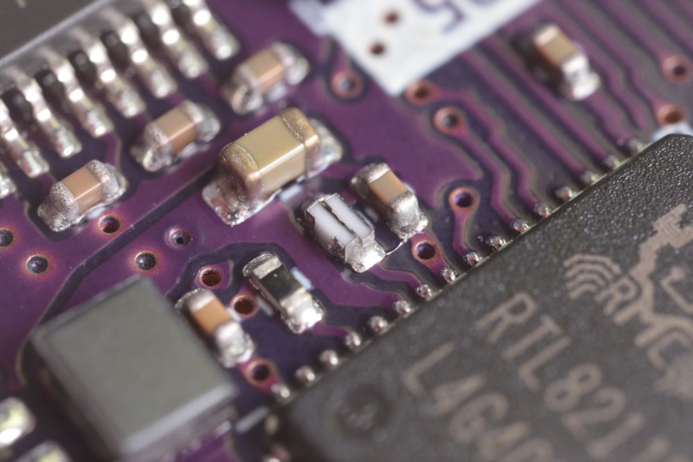 Components on solderpaste. The center of the image is two resistors back to back sitting sideways on the space typically taken by a single resistor.