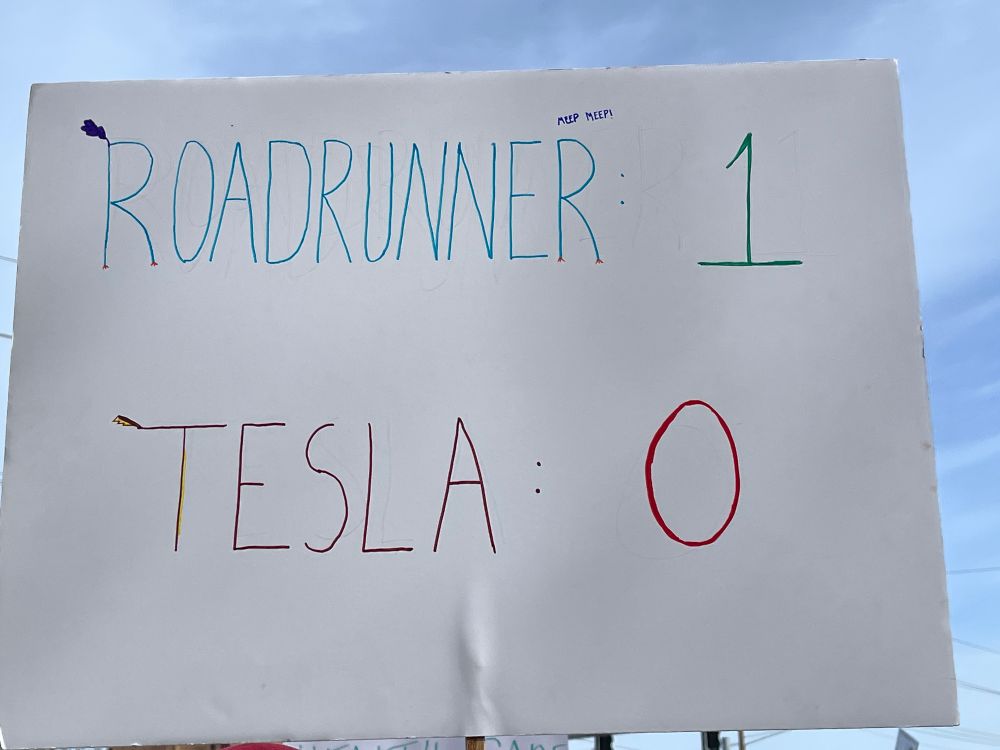 Sign says roadrunner 1 Tesla 0