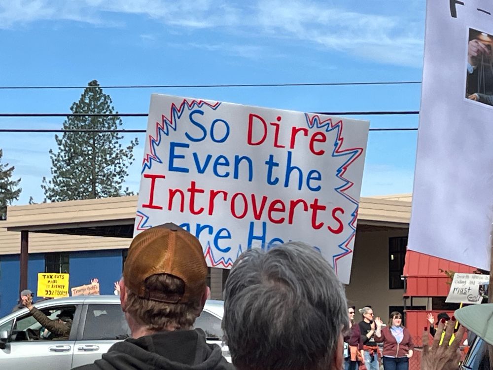 Sign says “so dire even the introverts are here”